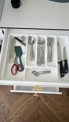 a drawer filled with utensils in a kitchen at Sunrise Uzupis Apartment in Vilnius