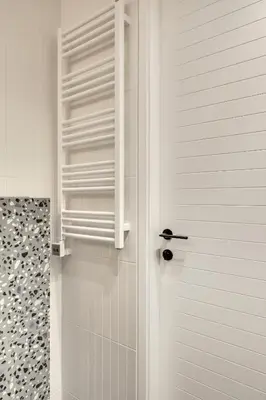a bathroom with a shower with a door and a shower at Sunrise Uzupis Apartment in Vilnius