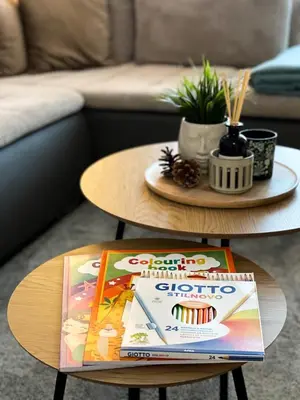 a coffee table with a book on top of it at Mocha Apartment in Druskininkai