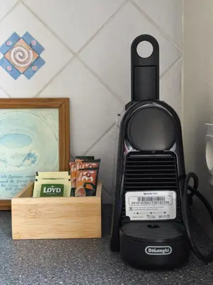 a black blender sitting next to a wooden box at Mocha Apartment in Druskininkai