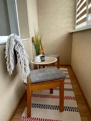 a stair room with a table and a chair and a table at Mocha Apartment in Druskininkai