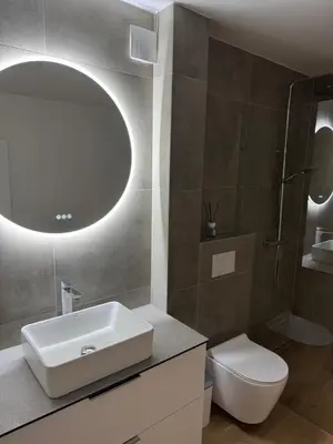 a bathroom with a sink and a toilet and a mirror at Gilės namai in Kaunas