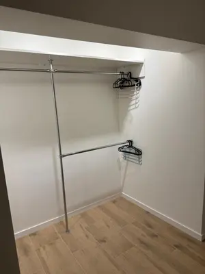 a room with white walls and metal shelves at Gilės namai in Kaunas