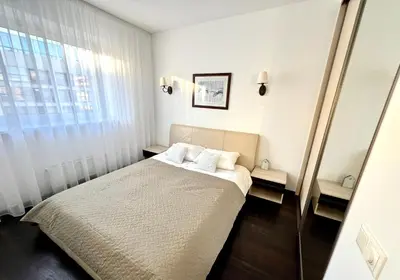 a bedroom with a bed and a window at Zygio Apartamentai in Vilnius