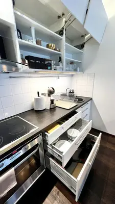 a kitchen with an open drawer in a kitchen at Zygio Apartamentai in Vilnius