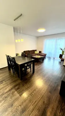 a living room with a table and a couch at Zygio Apartamentai in Vilnius