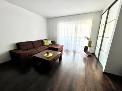 a living room with a couch and a coffee table at Zygio Apartamentai in Vilnius