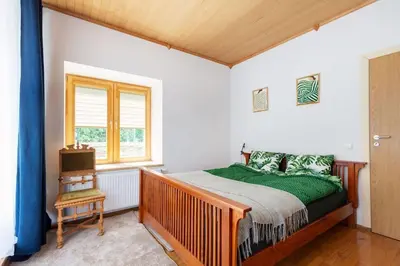a bedroom with a bed and a window at Vilnius Pinewood Apartment in Vilnius