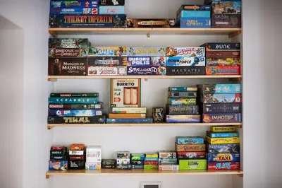 a book shelf filled with lots of books at Vilnius Pinewood Apartment in Vilnius