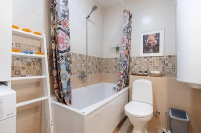 a bathroom with a bath tub and a toilet at Vilnius Pinewood Apartment in Vilnius