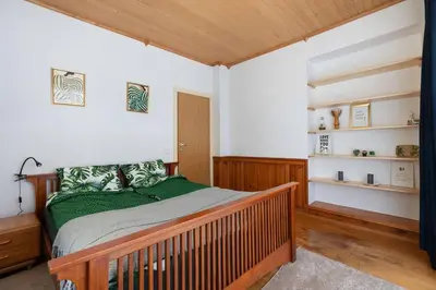 a bedroom with a wooden bed in a room at Vilnius Pinewood Apartment in Vilnius