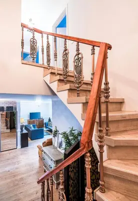 a staircase in a home with wooden railings at Blue Hound Cottage in Kaunas