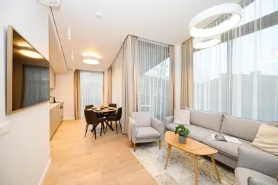 a living room with a couch and a table at 2BD NEW Apt w-Balcony I Parking inc I next to the River and Forest I by Cohost in Birštonas