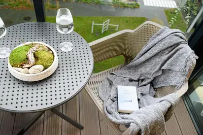 a table on a balcony with a bowl of moss at 2BD NEW Apt w-Balcony I Parking inc I next to the River and Forest I by Cohost in Birštonas