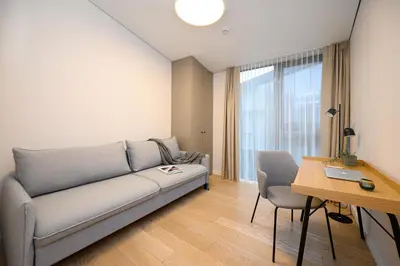 a living room with a couch and a table at 2BD NEW Apt w-Balcony I Parking inc I next to the River and Forest I by Cohost in Birštonas