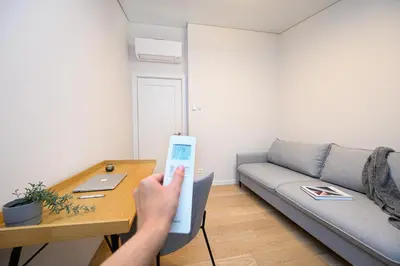 a person holding a wii remote in a living room at 2BD NEW Apt w-Balcony I Parking inc I next to the River and Forest I by Cohost in Birštonas