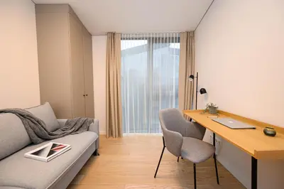 a living room with a couch and a desk at 2BD NEW Apt w-Balcony I Parking inc I next to the River and Forest I by Cohost in Birštonas