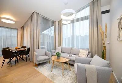 a living room with a couch and a table at 2BD NEW Apt w-Balcony I Parking inc I next to the River and Forest I by Cohost in Birštonas