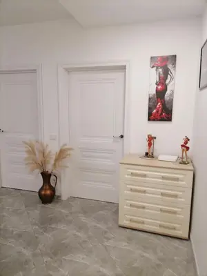 a white room with a dresser and a white door at Privatus 2kambariu butas in Birštonas