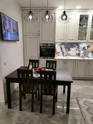 a kitchen with a dining room table and chairs at Privatus 2kambariu butas in Birštonas