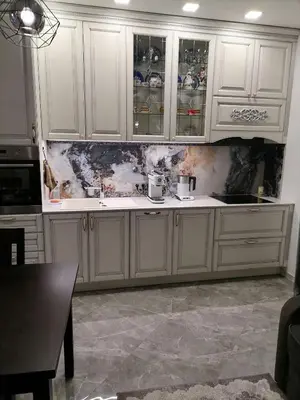a kitchen with white cabinets and a damaged wall at Privatus 2kambariu butas in Birštonas