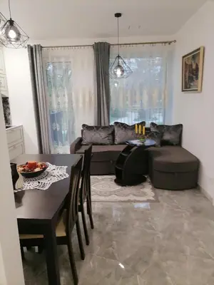 a living room with a table and a couch at Privatus 2kambariu butas in Birštonas