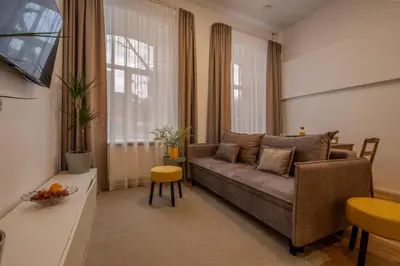 a living room with a couch and a table at Railway Apartments in Vilnius