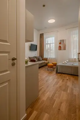 a room with a bed and a living room at Railway Apartments in Vilnius