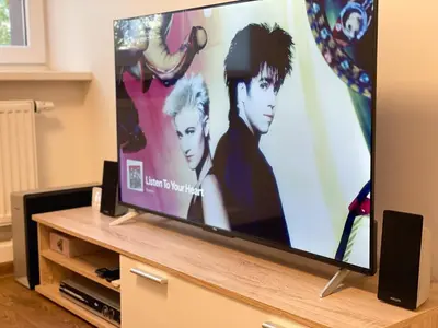 a flat screen tv sitting on top of a entertainment center at IG Apartments in Karmėlava