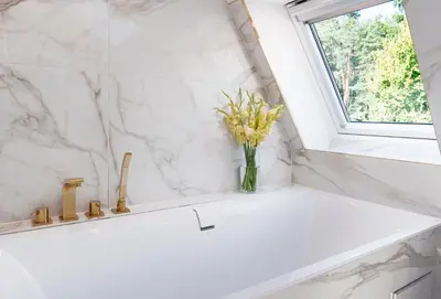a vase of flowers sitting on a counter in a bathroom at Luxury villa with sauna in the pine forest close to Vilnius city centre in Vilnius