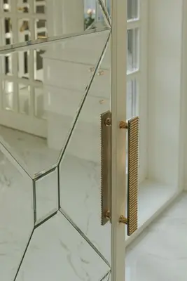 a glass door with a handle in a room at Luxury villa with sauna in the pine forest close to Vilnius city centre in Vilnius