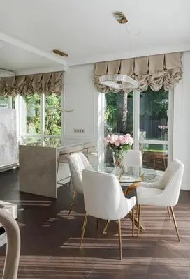 a dining room with a glass table and white chairs at Luxury villa with sauna in the pine forest close to Vilnius city centre in Vilnius