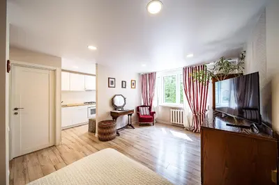 a living room with a flat screen tv next to a door at Thibo Apartamentas in Šiauliai