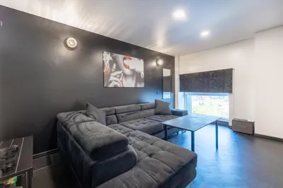 a living room with a couch and a table at Top Loft Kaunas in Kaunas