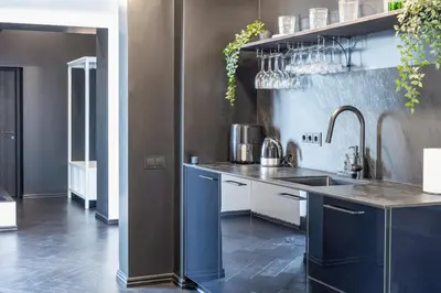 a kitchen with blue cabinets and a sink at Top Loft Kaunas in Kaunas