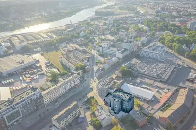 an overhead view of a city with buildings and a river at Top Loft Kaunas in Kaunas
