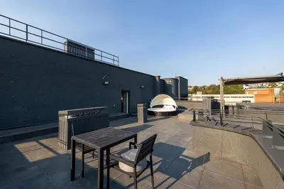 a patio with a table and a stove on a building at Top Loft Kaunas in Kaunas