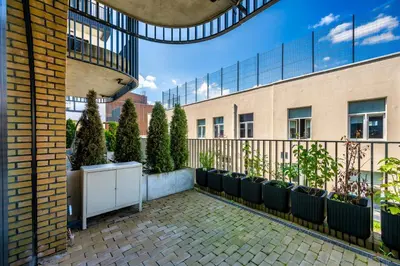 a balcony with chairs and plants in a building at Old Town Luxury Apartments in Vilnius