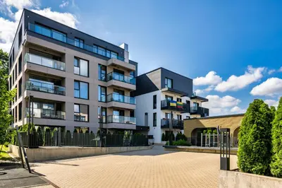 an apartment building in front of a fence at Old Town Luxury Apartments in Vilnius