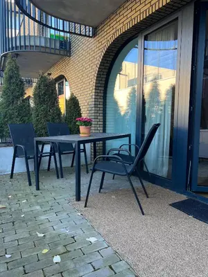 a table and chairs sitting on a patio at Old Town Luxury Apartments in Vilnius