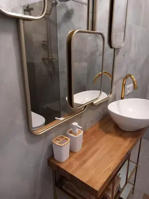 a bathroom with a sink and two mirrors at SPA TOWN house II in Druskininkai