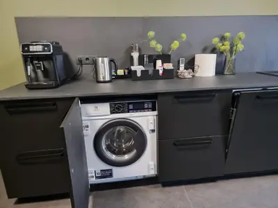 a kitchen counter with a washing machine in a kitchen at Durpyno 3c SELF CHECK-IN in Panevėžys