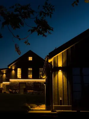 a barn at night with the lights on at Lakeview Modern Karaim Cottage Trakai in Trakai