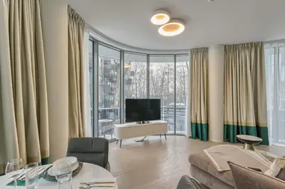 a living room with a couch and a television at Drusk Sun in Druskininkai