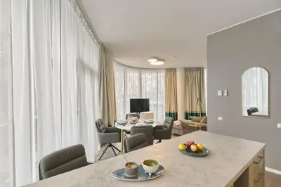 a kitchen and living room with a table with fruit on it at Drusk Sun in Druskininkai