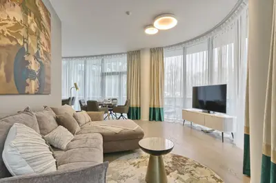 a living room with a couch and a tv at Drusk Sun in Druskininkai