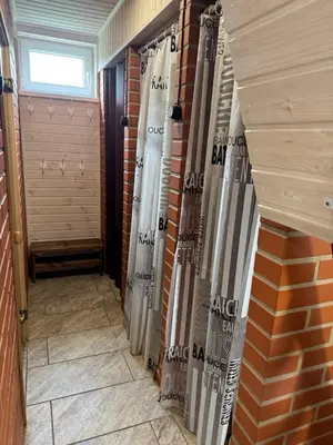 a hallway of a house with a brick wall at Pinetree House in Gudeliai
