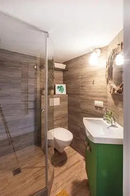 a bathroom with a toilet and a sink and a shower at Jungle in Vilnius City Center by URBAN RENT in Vilnius