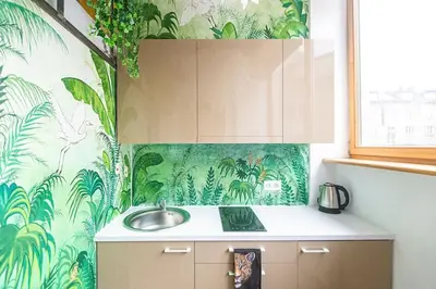 a kitchen with a sink and a tropical wallpaper at Jungle in Vilnius City Center by URBAN RENT in Vilnius