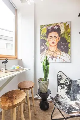 a kitchen with two stools and a painting on the wall at Jungle in Vilnius City Center by URBAN RENT in Vilnius